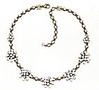 image for necklace Magic Fireball white antique brass (5 flowers along half the neckline)